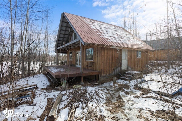 snow covered structure featuring french doors
