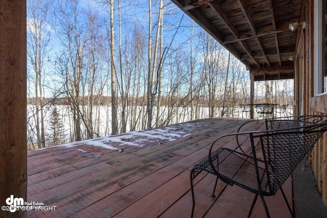 wooden terrace with outdoor dining space