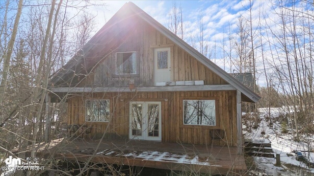 snow covered structure with french doors