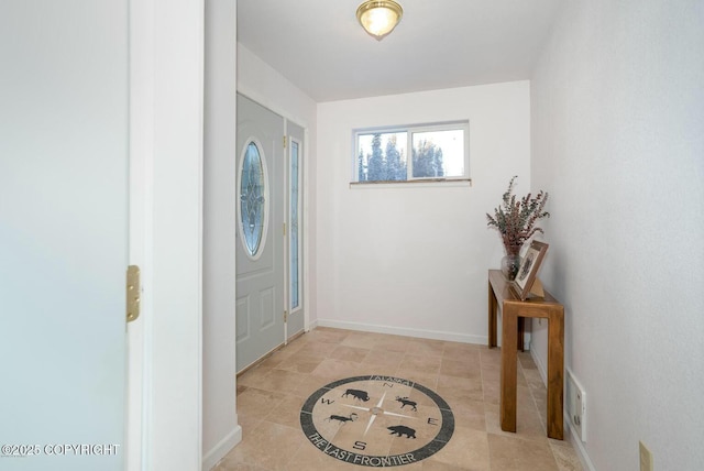 foyer entrance with tile patterned flooring and baseboards