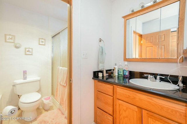 full bathroom with toilet, a shower stall, tile patterned flooring, and vanity