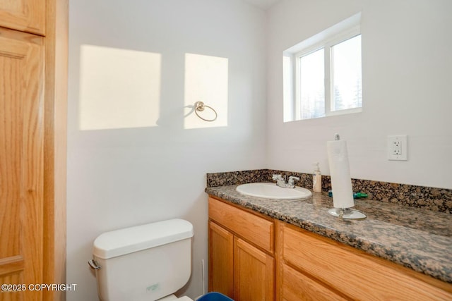 bathroom featuring toilet and vanity