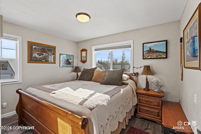 bedroom with dark wood finished floors