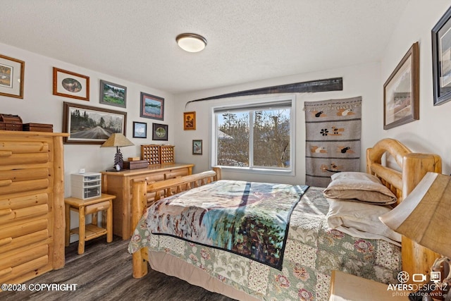 bedroom with a textured ceiling and wood finished floors