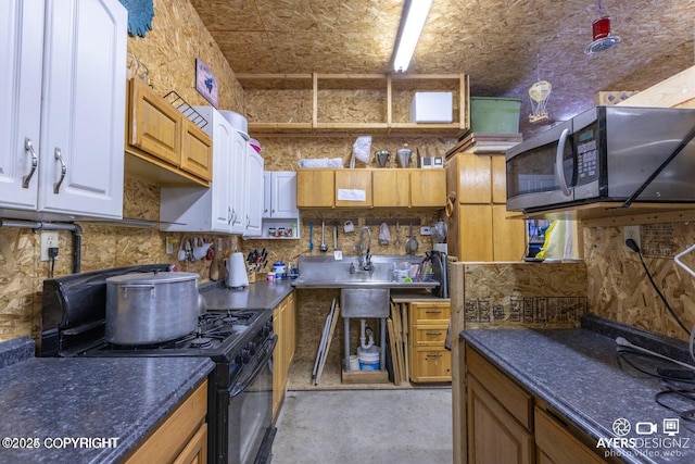 kitchen featuring stainless steel microwave, tasteful backsplash, dark countertops, and black gas stove