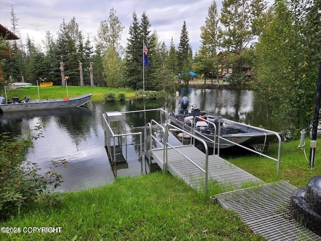 dock area with a lawn and a water view