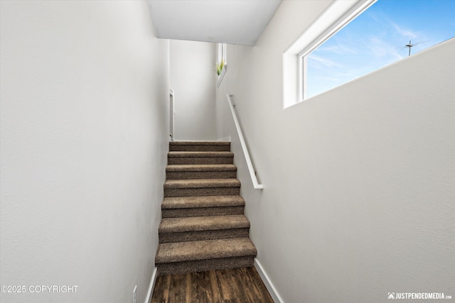 stairs with baseboards and wood finished floors