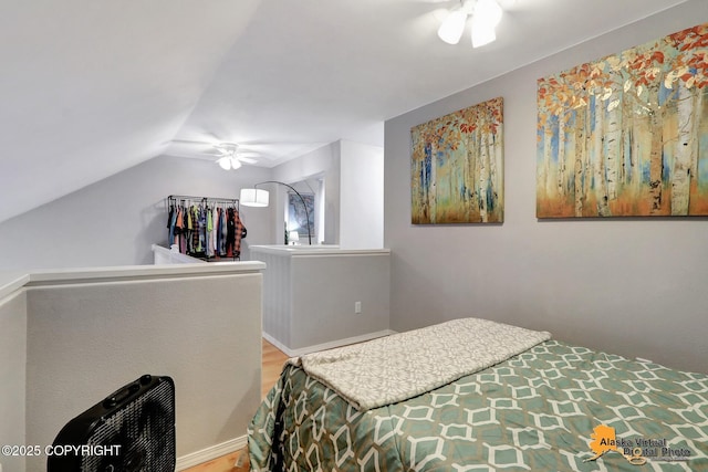 bedroom with lofted ceiling, ceiling fan, and wood finished floors