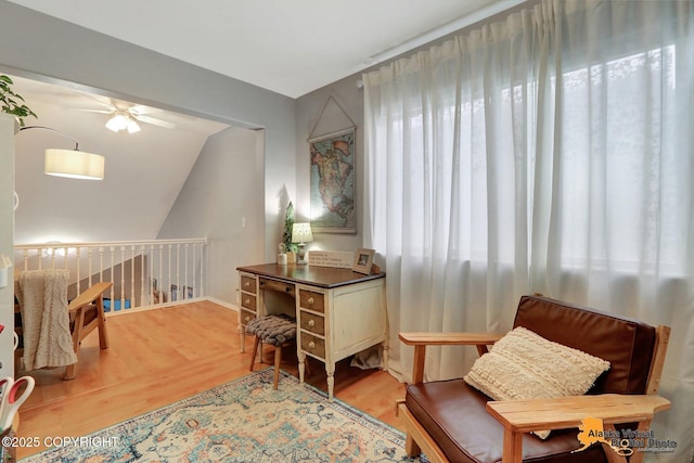 sitting room with a ceiling fan and light wood-type flooring