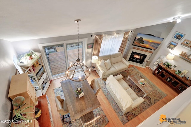 living room featuring wood finished floors and a tile fireplace