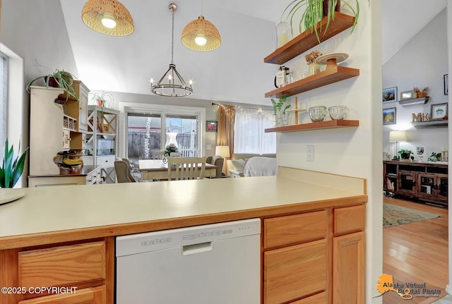 kitchen with lofted ceiling, light countertops, dishwasher, open shelves, and an inviting chandelier