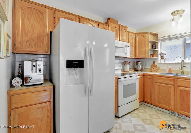 kitchen featuring white appliances, a sink, visible vents, light countertops, and light floors