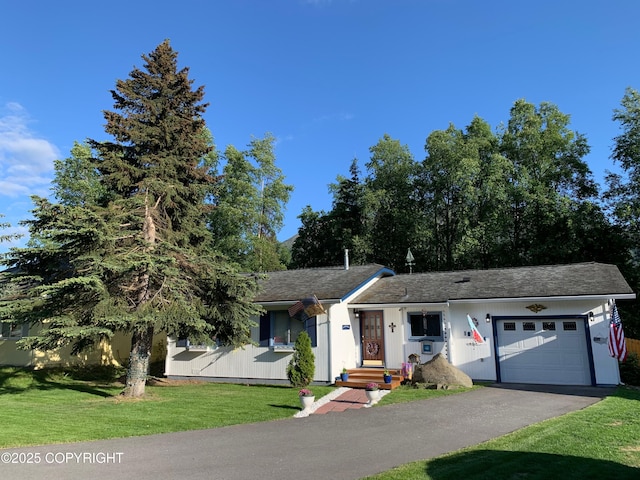 view of front of property with aphalt driveway, an attached garage, and a front lawn