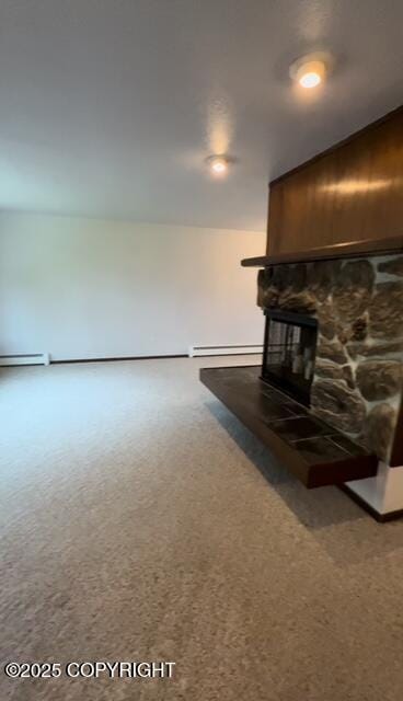 unfurnished living room with carpet floors, a fireplace, and baseboard heating