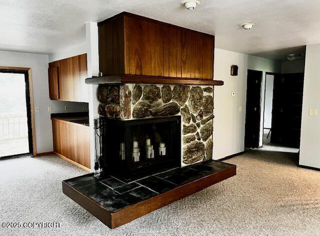 details with carpet, a fireplace, baseboards, and a textured ceiling