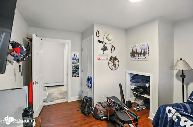 7210 Akutan Cir, Anchorage, AK 99504 - bedroom featuring a baseboard radiator and wood finished floors