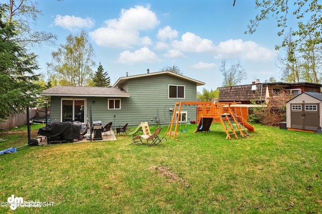 7210 Akutan Cir, Anchorage, AK 99504 - rear view of house with a storage shed, a playground, and an outbuilding