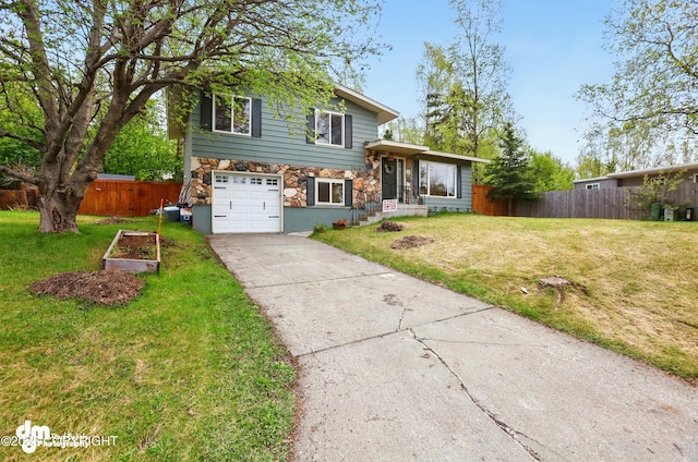 7210 Akutan Cir, Anchorage, AK 99504 - split level home with concrete driveway, stone siding, and an attached garage