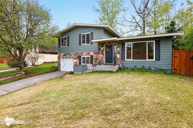 7210 Akutan Cir, Anchorage, AK 99504 - split level home featuring concrete driveway, a garage, and stone siding