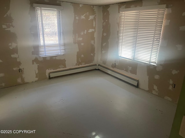 spare room featuring a wealth of natural light and baseboard heating