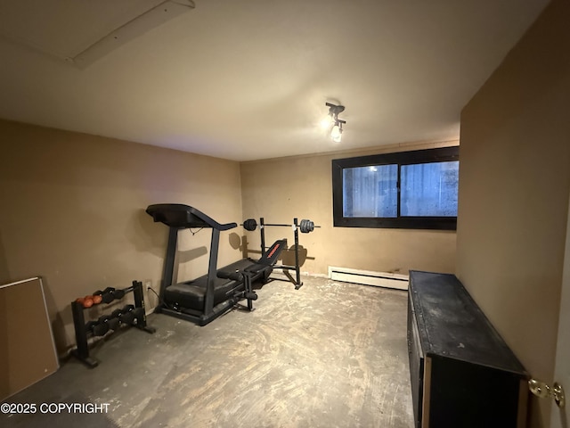 exercise area featuring a baseboard heating unit