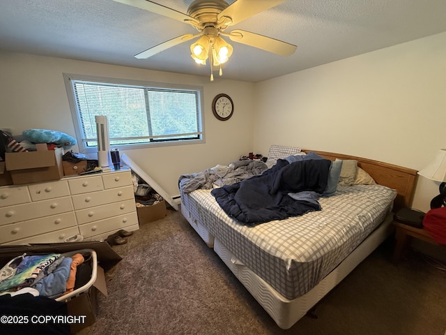 carpeted bedroom with a ceiling fan and a textured ceiling