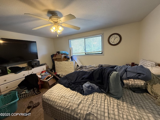 carpeted bedroom with ceiling fan and a textured ceiling