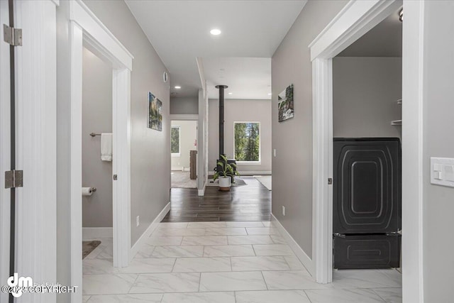 hallway with marble finish floor, recessed lighting, and baseboards