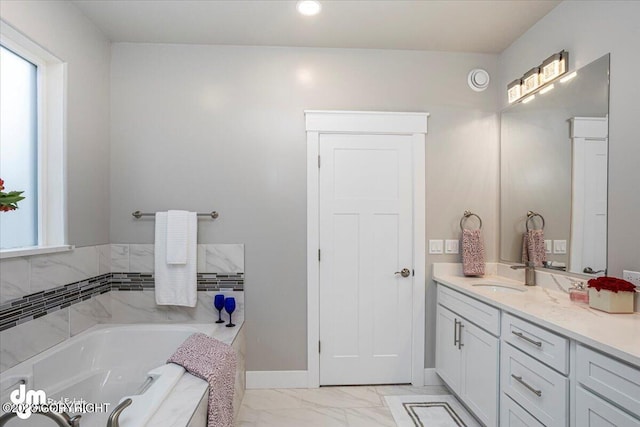 bathroom featuring marble finish floor, a garden tub, recessed lighting, vanity, and baseboards