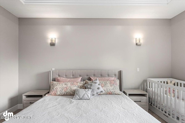 carpeted bedroom featuring baseboards