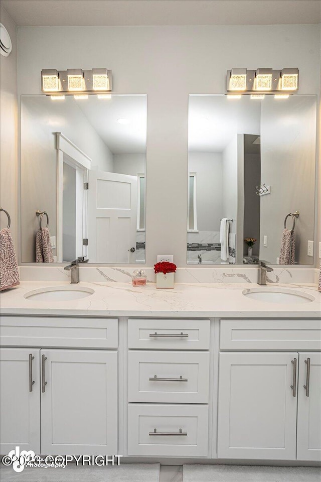 bathroom with double vanity and a sink