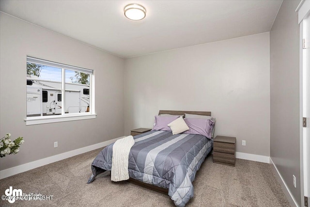 carpeted bedroom with baseboards