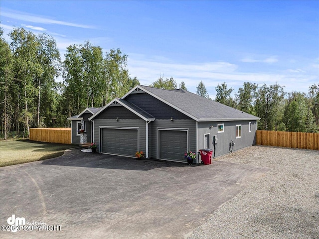 exterior space with a garage, fence, and driveway