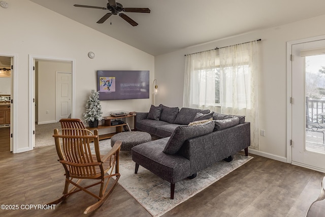 living area featuring lofted ceiling, wood finished floors, baseboards, and ceiling fan