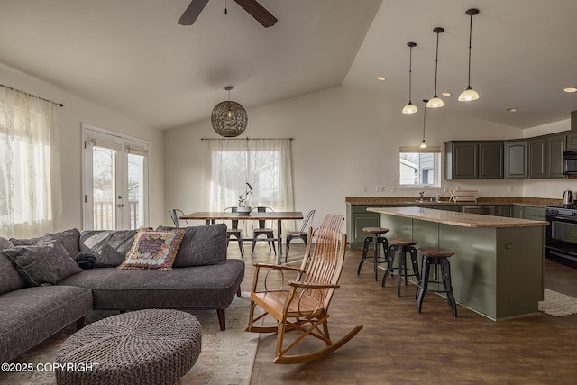 living area with lofted ceiling, recessed lighting, and ceiling fan