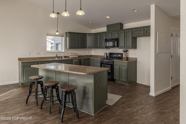 kitchen with dark countertops, a center island, a breakfast bar, lofted ceiling, and black appliances