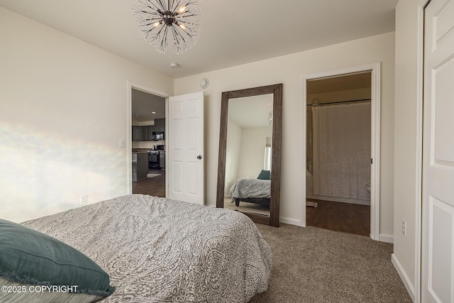 bedroom featuring carpet flooring, ensuite bathroom, and baseboards