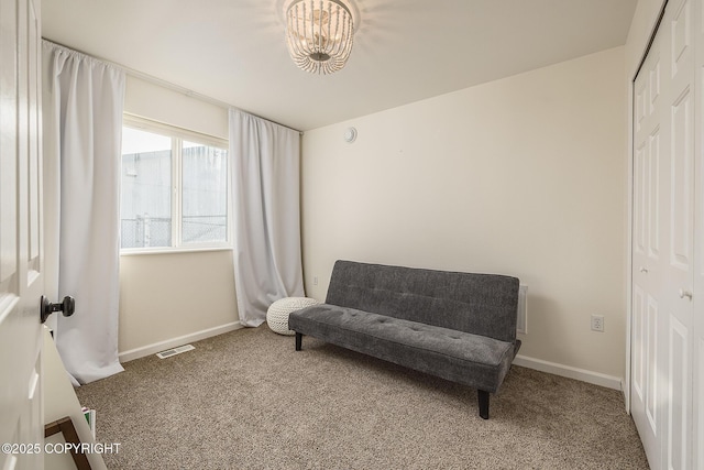 sitting room with carpet, visible vents, and baseboards