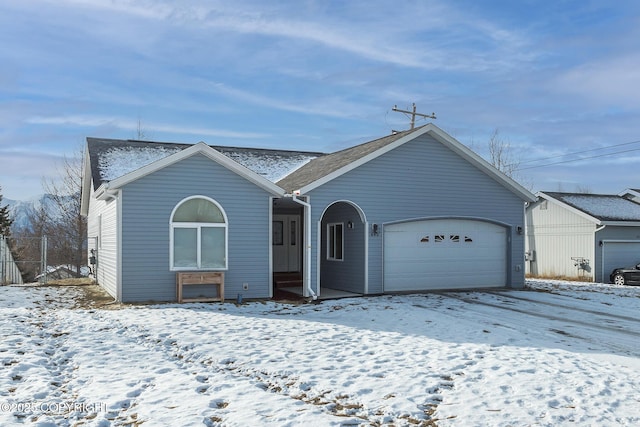 ranch-style home with a garage and fence