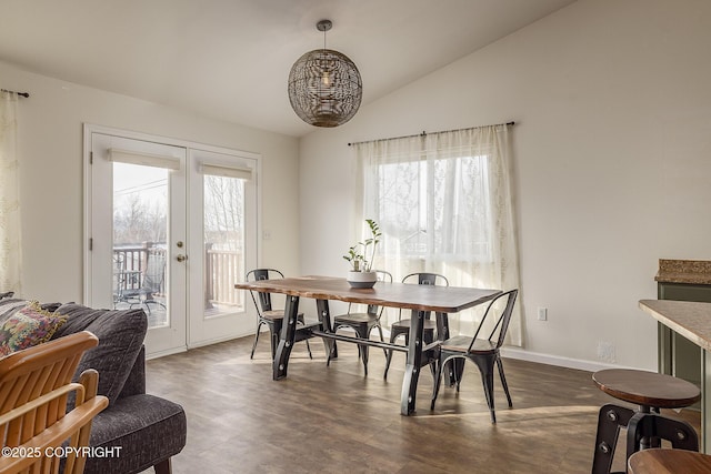 dining area featuring vaulted ceiling, plenty of natural light, french doors, and baseboards