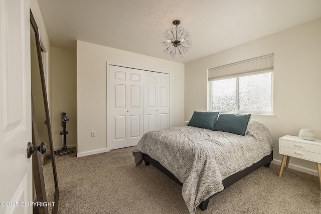 carpeted bedroom with a closet and baseboards