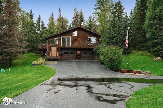 view of front of property with aphalt driveway, a garage, and a front lawn