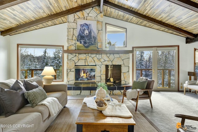 carpeted living area with beam ceiling, a fireplace, and wood ceiling