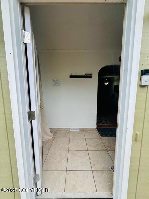 hall featuring light tile patterned floors