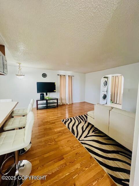 living room with a textured ceiling and wood finished floors