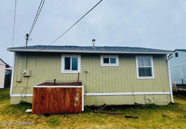 rear view of property with a yard