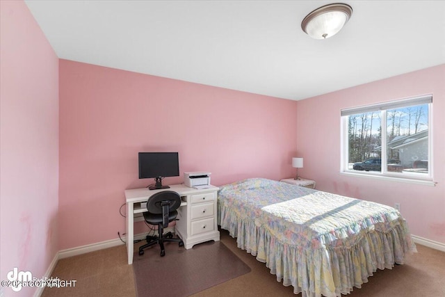 carpeted bedroom featuring baseboards