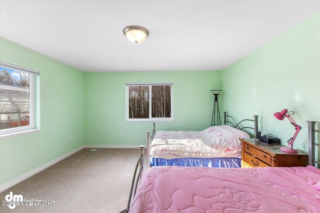 carpeted bedroom with baseboards