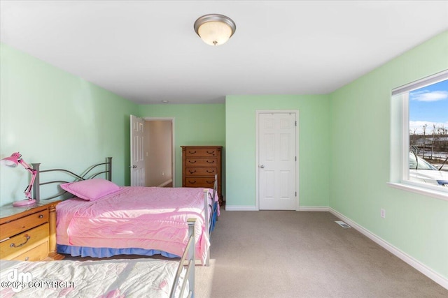 carpeted bedroom with visible vents and baseboards