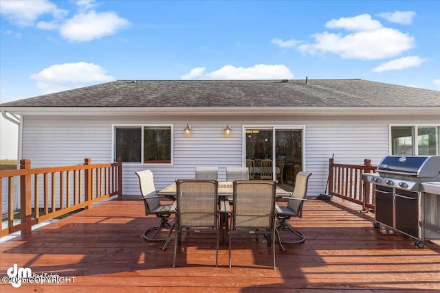 wooden terrace featuring outdoor dining space and a grill